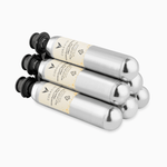 Four Coravin gas cartridges stacked, featuring silver bodies and black tops, with visible branding and usage instructions.