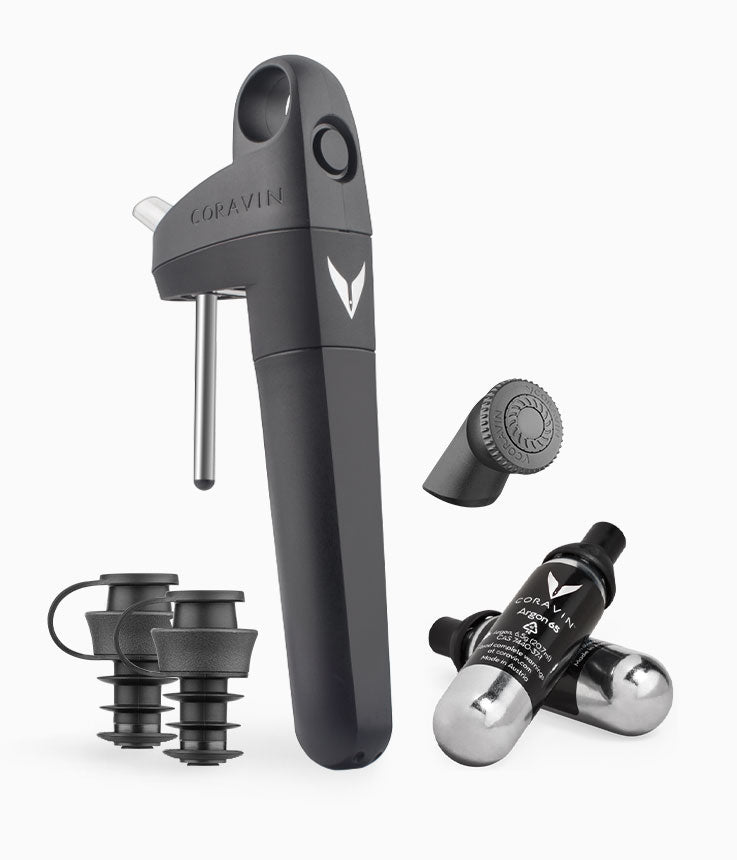 Coravin wine preservation system, including a pourer, capsules, and cork stoppers, arranged on a white background.