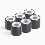 Six black Coravin capsules stacked, each featuring a round white top with the Coravin logo and a colored dot in the center.