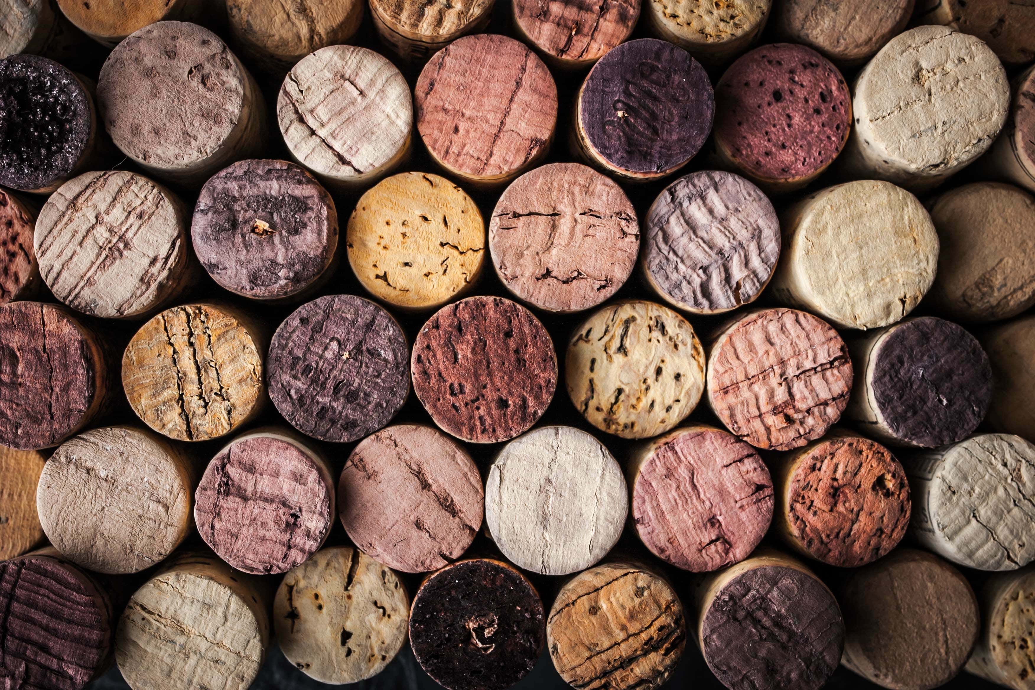 Close-up of stacked wine corks showing varied textures and shades from red and white wines.