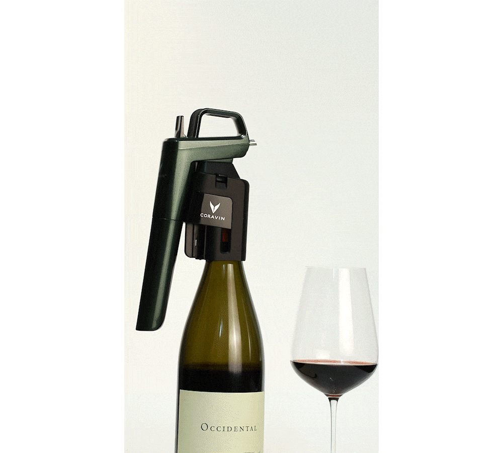 Coravin wine opener attached to a bottle labeled "Occidental" next to a glass of red wine.