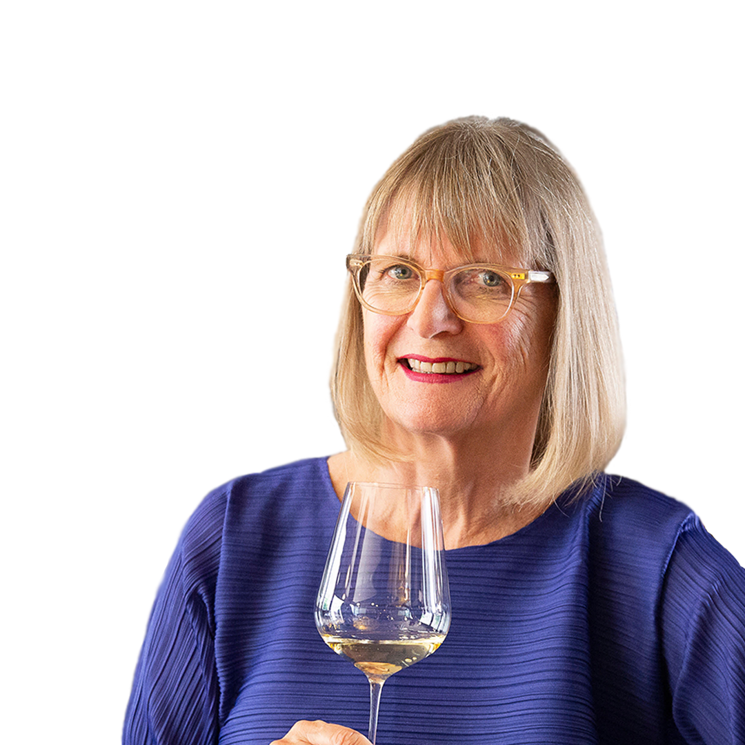 Jancis Robinson holding a glass of white wine against a white background